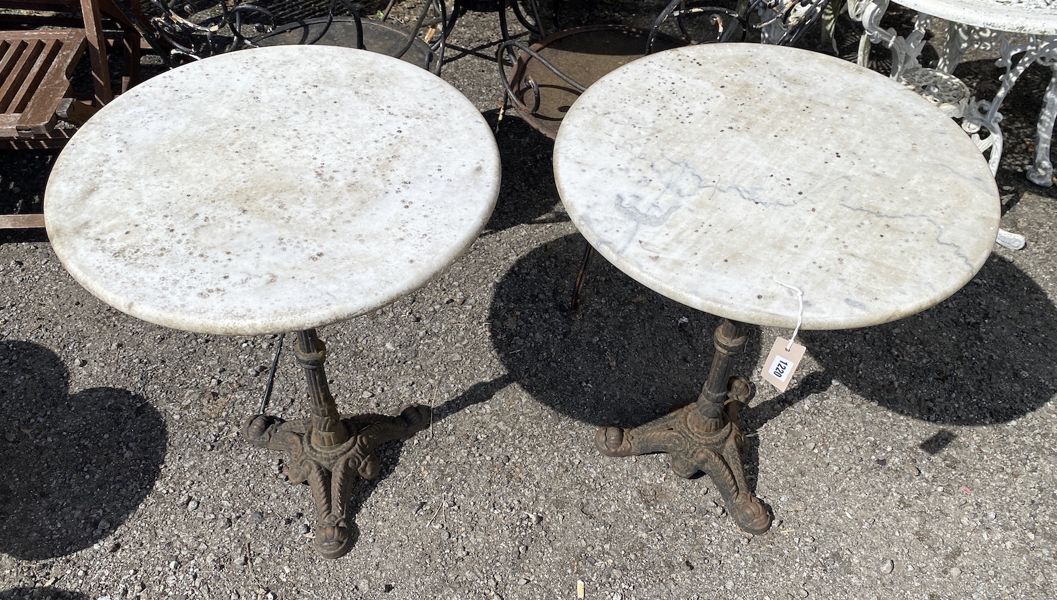 A pair of circular reconstituted marble and cast metal pub tables, diameter 60cm, height 70cm